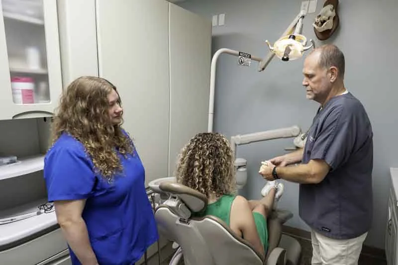 Dr. Dickey talking with his patient at Big River Dental
