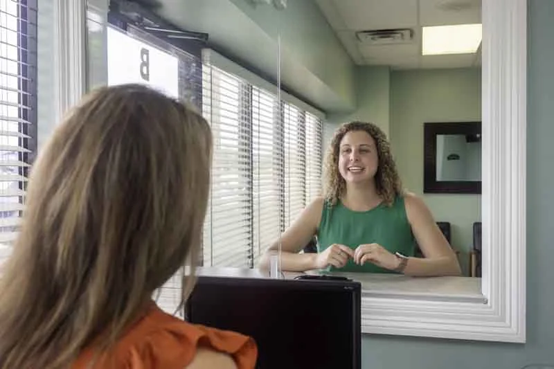 woman checking out at Big River Dental